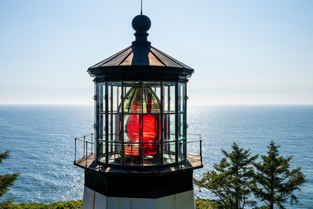 Top of lighthouse with red lamp on headland at Cape Meares National Wildlife Refuge, Three Capes Scenic Loop, summer road trip to explore Oregon State Parks on the coast