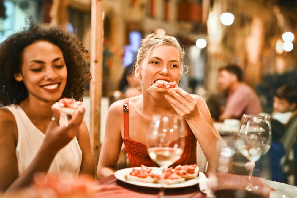 Friends eating pizza at a restaurant